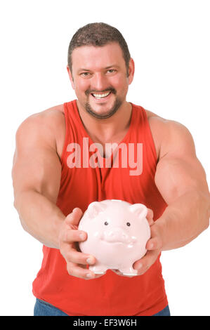 Muscular man holding piggy bank Banque D'Images