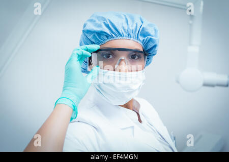 Dentiste femme portant un masque chirurgical et des lunettes Banque D'Images