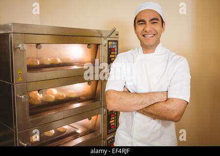 Baker smiling at camera à côté de four Banque D'Images