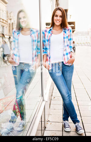 Portrait of young woman with hands in pockets