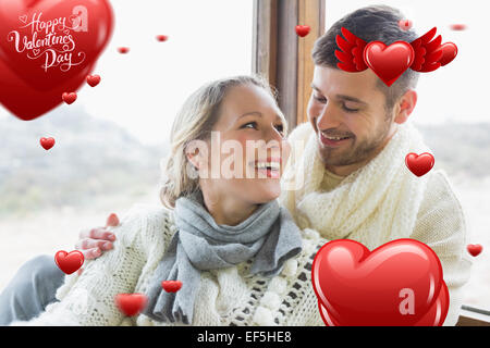 Image composite de cheerful young couple in winter clothing Banque D'Images