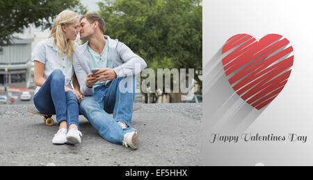 Image composite du hip young couple sitting on skateboard kissing Banque D'Images