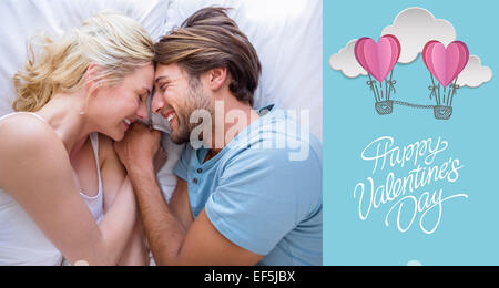 Image composite de cute couple relaxing on bed smiling at each other Banque D'Images