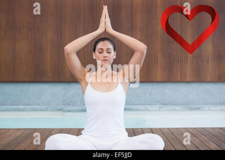 Image composite de la femme en blanc assis en posture de lotus Banque D'Images