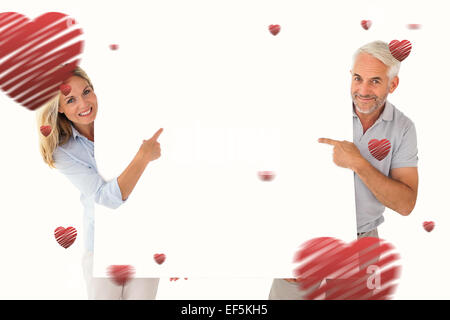 Image composite de l'heureux couple holding et se dirigeant à grande affiche Banque D'Images