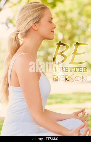 Composite image ponytailed calm woman sitting assis dans un parc Banque D'Images