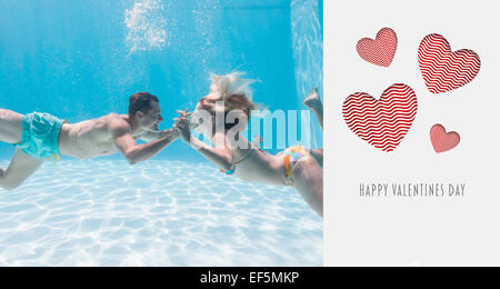Image composite de cute couple sous l'eau dans la piscine Banque D'Images