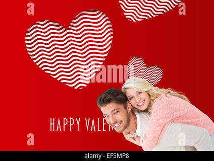 Image composite de handsome man giving piggy back pour sa petite amie Banque D'Images