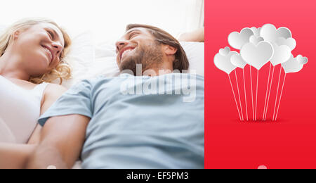 Image composite de cute couple lying on a bed Banque D'Images