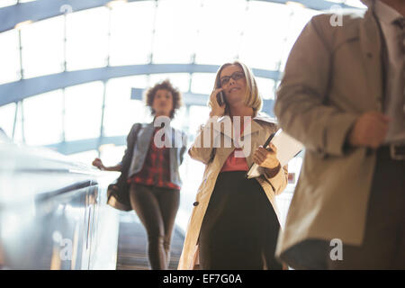 Low angle view of business people riding escalator Banque D'Images