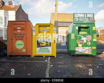 La charité des vêtements, des chaussures et des bacs de recyclage de tissu dans un parking Banque D'Images