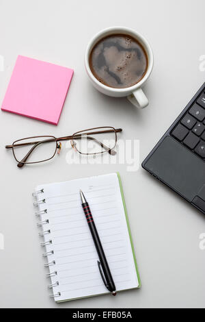 Office de bureau avec bloc-notes, café et verres. D'en haut Banque D'Images