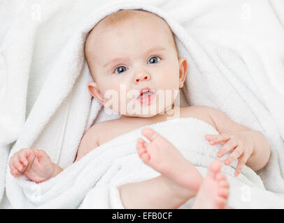 Cute baby girl lying on serviette blanche Banque D'Images