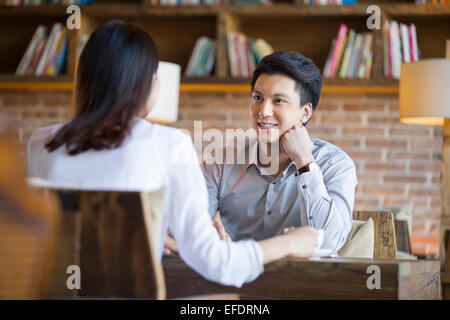 Jeune femme et l'homme parler in cafe Banque D'Images