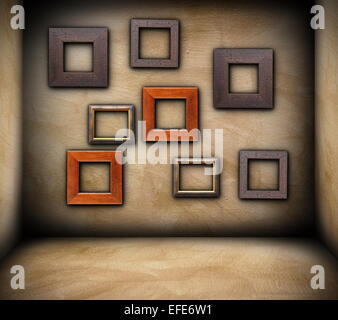 Cadres en bois sur grungy mur de salle vide, toile Banque D'Images