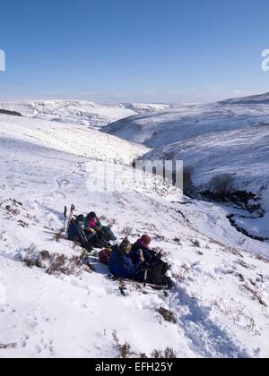 Une belle journée dans l'hivers Parc national de Peak District, Derbyshire, Royaume-Uni. Un groupe de marcheurs grimper à l'Fairbrook Kinder du Scoutisme et de retour vers le bas du plateau  ? Fairbrook Banque D'Images