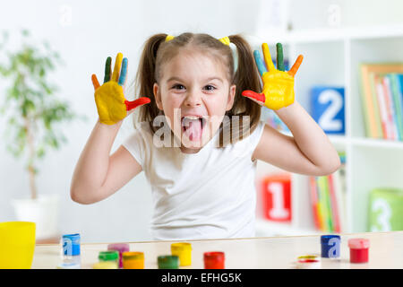 Funny kid avec mains peint en peinture colorée Banque D'Images