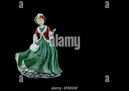 Figurine en porcelaine portant une robe rouge et verte Banque D'Images