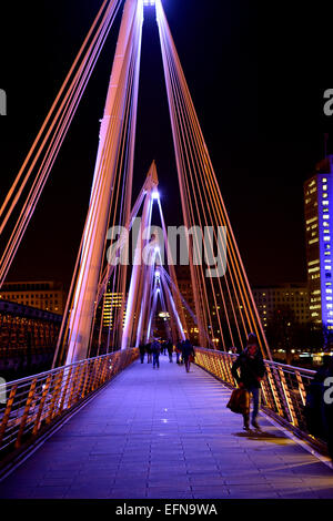 Marcher le long du London Hungerford Bridge at night Banque D'Images