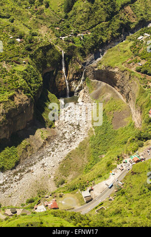 Une perspective aérienne capture une cascade plongeant d'une falaise abrupte et végétalisée dans une gorge rocheuse en contrebas. L'eau coule dans une piscine peu profonde entourée de gros rochers et d'un lit de rivière sec. Lush Banque D'Images