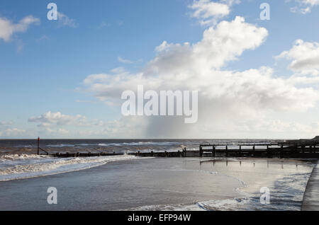 Plage de Walcott en hiver avec douche passant nuages sur le côte nord du comté de Norfolk, en Angleterre, Royaume-Uni Banque D'Images