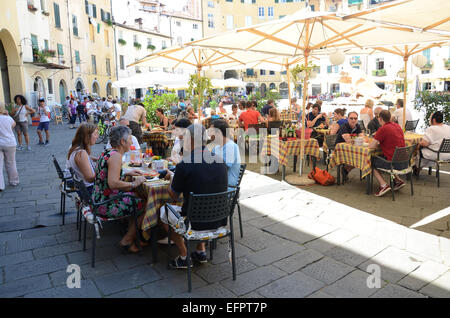 Les gens à manger la Piazza Anfiteatro, Lucca Italie Banque D'Images