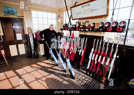 Le signaleur à Williton station sur la West Somerset Railway au travail dans son boîtier de signaux Banque D'Images