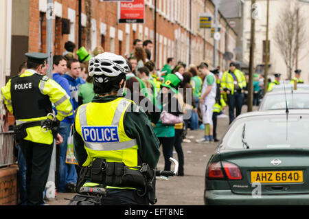 Gardez un oeil sur la police fêtards s'élève au cours de la fête de la Saint-Patrick à Belfast. Banque D'Images