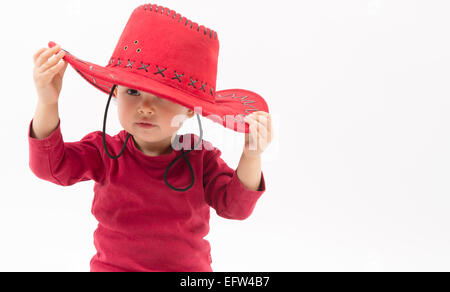 Little girl with red cowboy hat isolated on white Banque D'Images