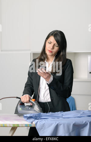 Femme au foyer malheureuse ennuyer faisant la planche sur le côté, regardant avec une expression mélancolique tout en consulter ses courriels Banque D'Images