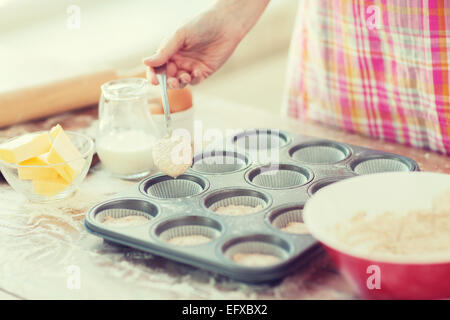 Remplissage de moules muffins avec la pâte Banque D'Images