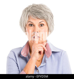 Portrait d'une femme âgée pour demander le silence Banque D'Images