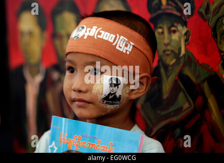 (150213) -- Yangon, le 13 février 2015 (Xinhua) -- un enfant avec un général Aung San autocollant sur sa joue pose pour une photo lors de l'anniversaire du centenaire de l'anniversaire du Général Aung San à Yangon, Myanmar, le 13 février 2015. Les trois jours de célébration du centenaire de l'anniversaire du Général Aung San (l'agent) se poursuivra jusqu'à samedi à la Place du Peuple à Yangon, Myanmar. Le 12 février 1947, toutes les nationalités du Myanmar, dirigé par le général Aung San, qui a eu lieu la Conférence de Panglong historique dans l'État Shan et signé l'Accord de Panglong, proclamant l'indépendance du pays. Cette journée a été désignée comme le Myanmar. Banque D'Images