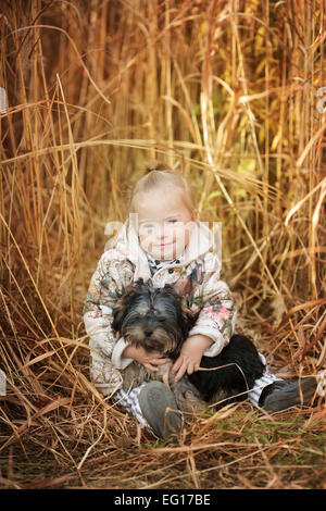 Belle fille avec le syndrome de hugs chiot Banque D'Images