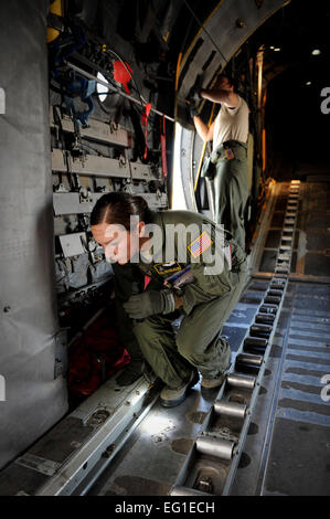 Les cadres supérieurs de l'US Air Force Airman Jordanna Wilson et Tech. Le Sgt. Jonathan Paszkot, tant avec le 36e Escadron de transport aérien, effectuer des vérifications de contrôle en amont d'un Hercules C-130 de la Force aérienne aéronefs cargos à Yokota Air Base, Japon, le 1 novembre 2011. Les aviateurs se préparent pour l'essor des samouraïs, au cours de laquelle la preuve de leurs équipages Yokota airdrop et grandes capacités de formation avec six C-130. Le s.. Stacy Moless Banque D'Images