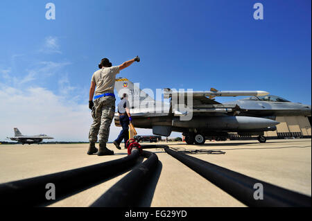 Un membre de la 1re classe Jason donne trou de pouce à un chef d'équipe avant de brancher un tuyau de carburant à un F-16 Fighting Falcon affecté à la 79e Escadron de chasse chez Shaw Air Force Base, S.C., le 26 juin 2012. Sex pit ravitaillement en vol est une procédure généralement effectuée dans une situation de combat d'avions de ravitaillement rapide alors que leurs moteurs sont en cours d'exécution, résultant en une solution rapide pour faire le plein de pilotes de butée à droite de nouveau dans la lutte. 20e trou est un escadron de préparation logistique fossiles de l'opérateur. Airman senior Publié par Kenny Holston Banque D'Images