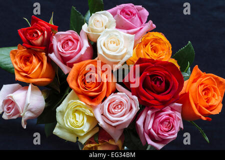 Bouquet de roses colorées contre surface sombre Banque D'Images