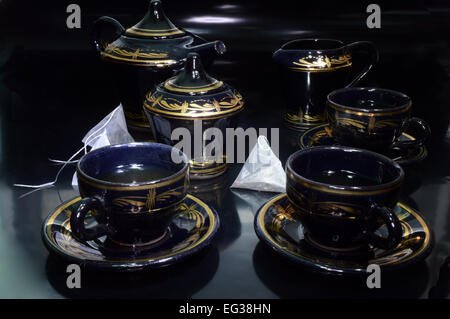 Tea party. Plateau de tasses à thé, et des sachets de thé sur fond noir Banque D'Images