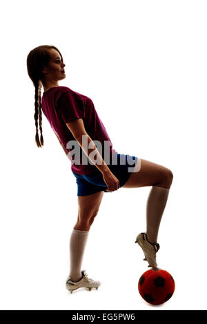 Silhouette de jeune fille jouant au football sur le livre blanc Banque D'Images