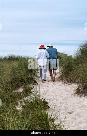 Mature couple walking un chemin des dunes de la plage, Cape Cod, Massachusetts, USA Banque D'Images