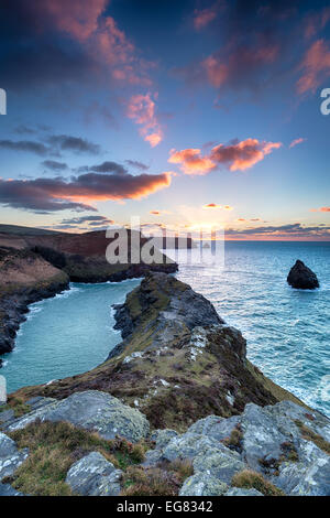 Beau coucher de soleil spectaculaire sur les falaises escarpées à Boscaslte treacheous sur la côte nord de Cornwall Banque D'Images