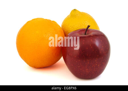 Pomme rouge, jaune citron et une orange sur un fond lumineux Banque D'Images