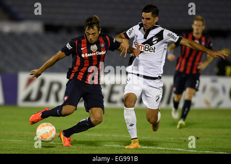 Montevideo, Uruguay. Feb 19, 2015. Danubio's Matias Castro (R) de l'Uruguay des eddv pour le bal avec San Lorenzo's Matias Catalan de l'Argentine lors du match de Coupe Libertadores, au stade du centenaire, à Montevideo, capitale de l'Uruguay, le 19 février, 2015. Crédit : Nicolas Celaya/Xinhua/Alamy Live News Banque D'Images