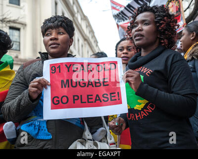 Londres, Royaume-Uni. 21 Février, 2015. Les activistes de l'extérieur de l'Ambassade du Zimbabwe dansent et chantent pour protester contre Mugabe pour son 91e anniversaire. Credit : Pete Maclaine/Alamy Live News Banque D'Images