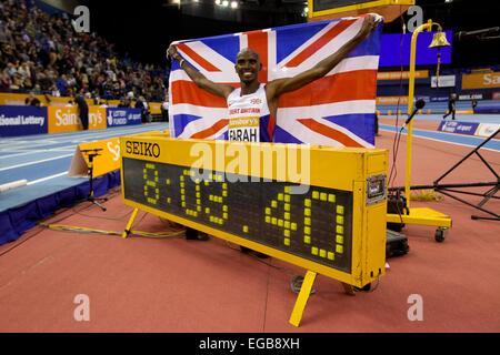 Birmingham, UK. Feb 21, 2015. Mo Farah pose pour les photographes avec l'union flag après avoir remporté le Men's 2 miles à l'événement Barclaycard Arena, Birmingham, UK, le samedi 21 février 2015. Farah a terminé avec un temps de 8:03:40, un nouveau record du monde, en battant le record précédent de sept ans de près d'une seconde. Crédit : Michael Buddle/Alamy Live News Banque D'Images