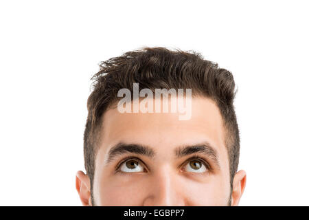 Portrait of a young man looking up, isolated on white Banque D'Images