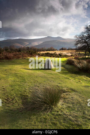 Standing Stone sur Mynydd Illtud commun dans le parc national de Brecon Beacons, avec des montagnes en arrière-plan et éclairé par le soleil Banque D'Images