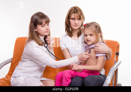 Médecin pédiatre examine un enfant malade à la maison en présence de ma mère Banque D'Images