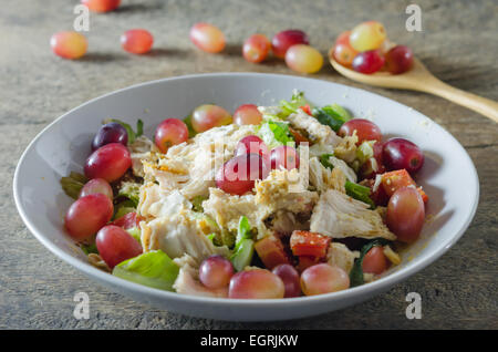 Mélanger avec la salade de poulet et les raisins sur le plat blanc Banque D'Images