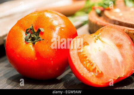 Tomates, cuit avec des herbes pour la préservation de la vieille table en bois. Banque D'Images